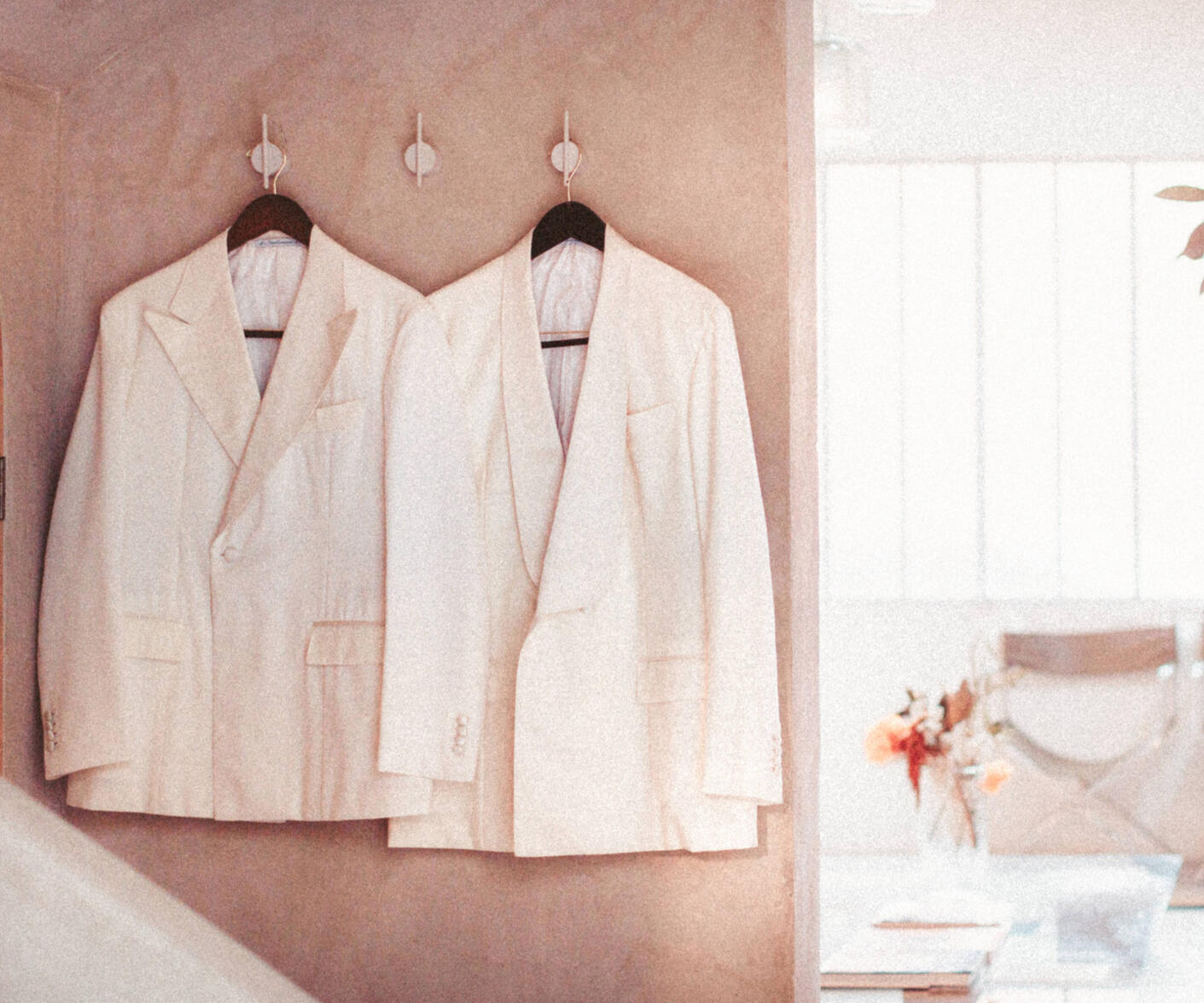Two ivory wedding jackets prepared for a celebration